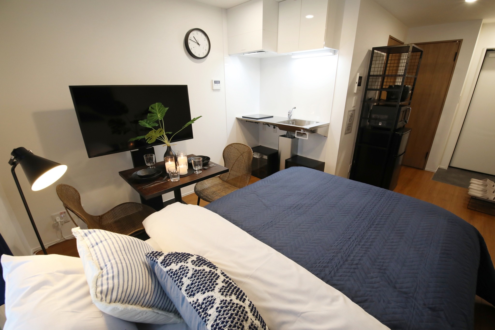 Room 202 LDK studio overview with kitchen, dining table and TV