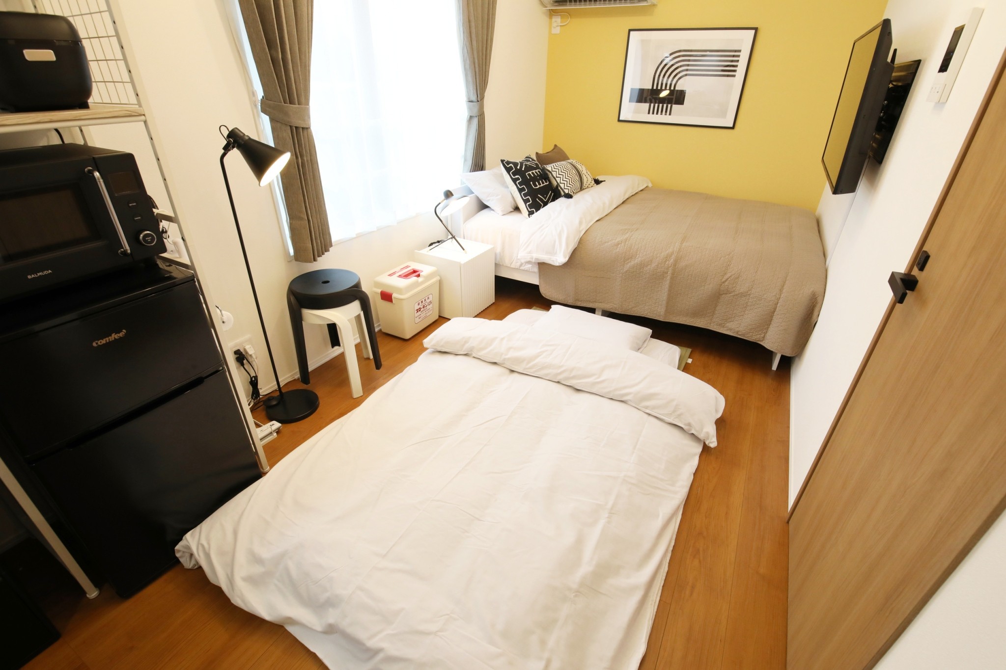 Room 401 bedroom with futon and appliances