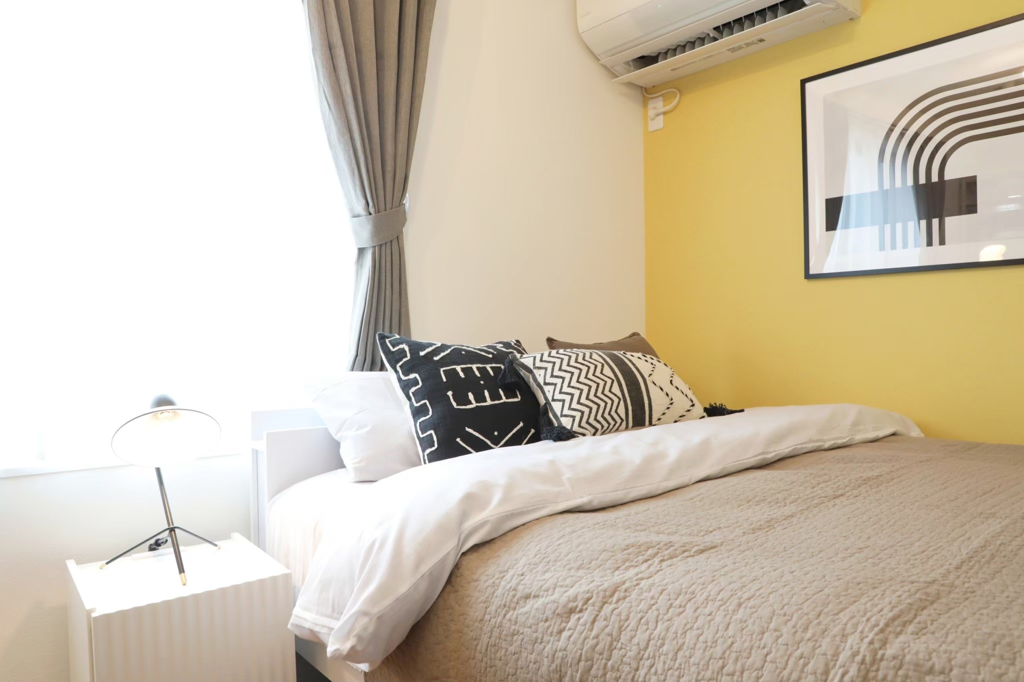 Room 401 bed with yellow accent wall