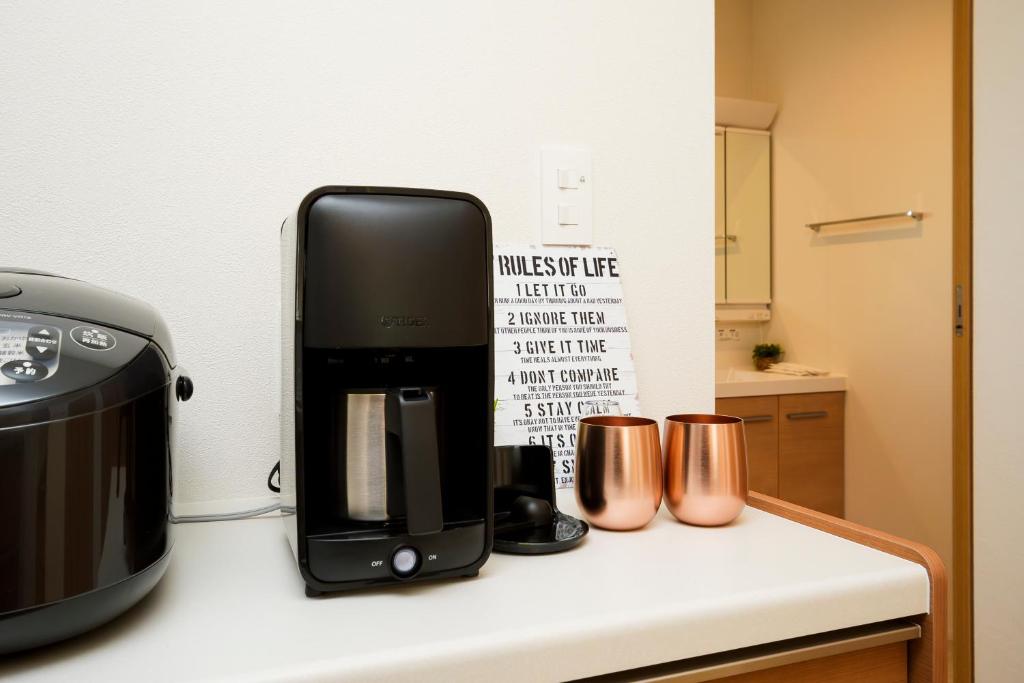 Zojirushi rice cooker and drip coffee maker on marble counter